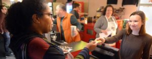 Dormont resident Veda Laine completes her snack bar purchase with theater employee Emily Mazur at the Breakfast and a Movie. Laine lives close enough to walk to the event, and has signed the petitions to preserve the Hollywood Theater.